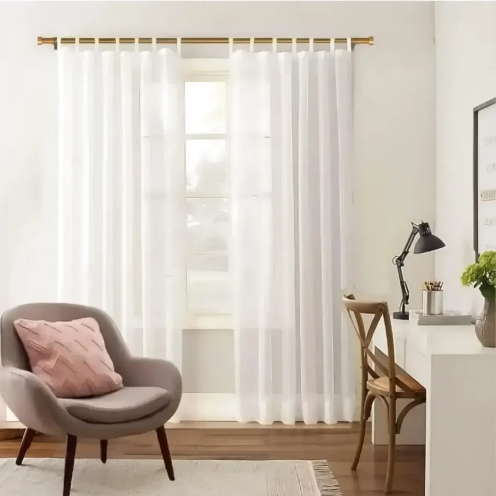Stylish living room with flowing sheer curtains on a adjustable curtain rod, paired with a single seater, and a table —creating a chic, inviting ambiance.